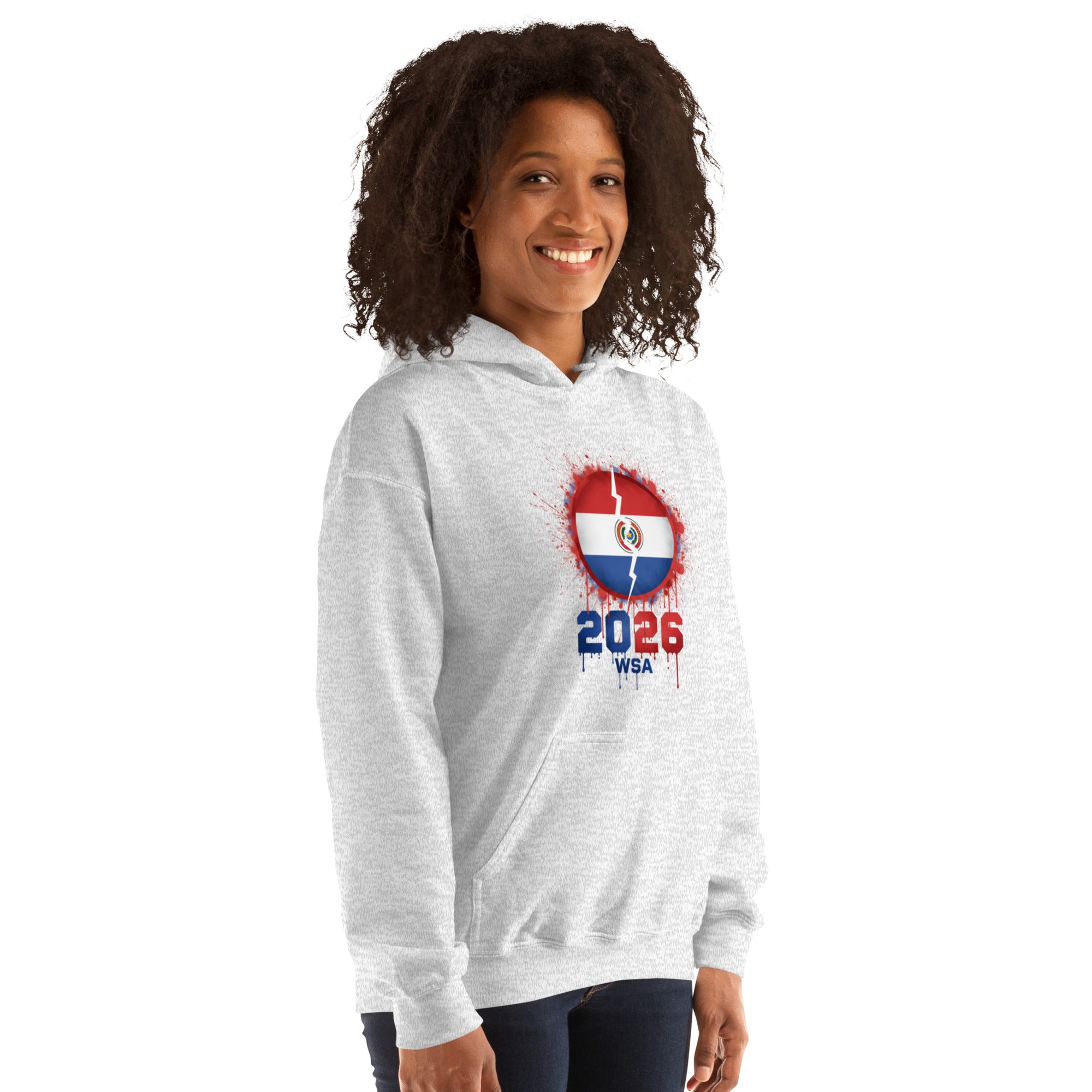 Person wearing a gray hoodie with a design featuring the number 2026 and text on a white background