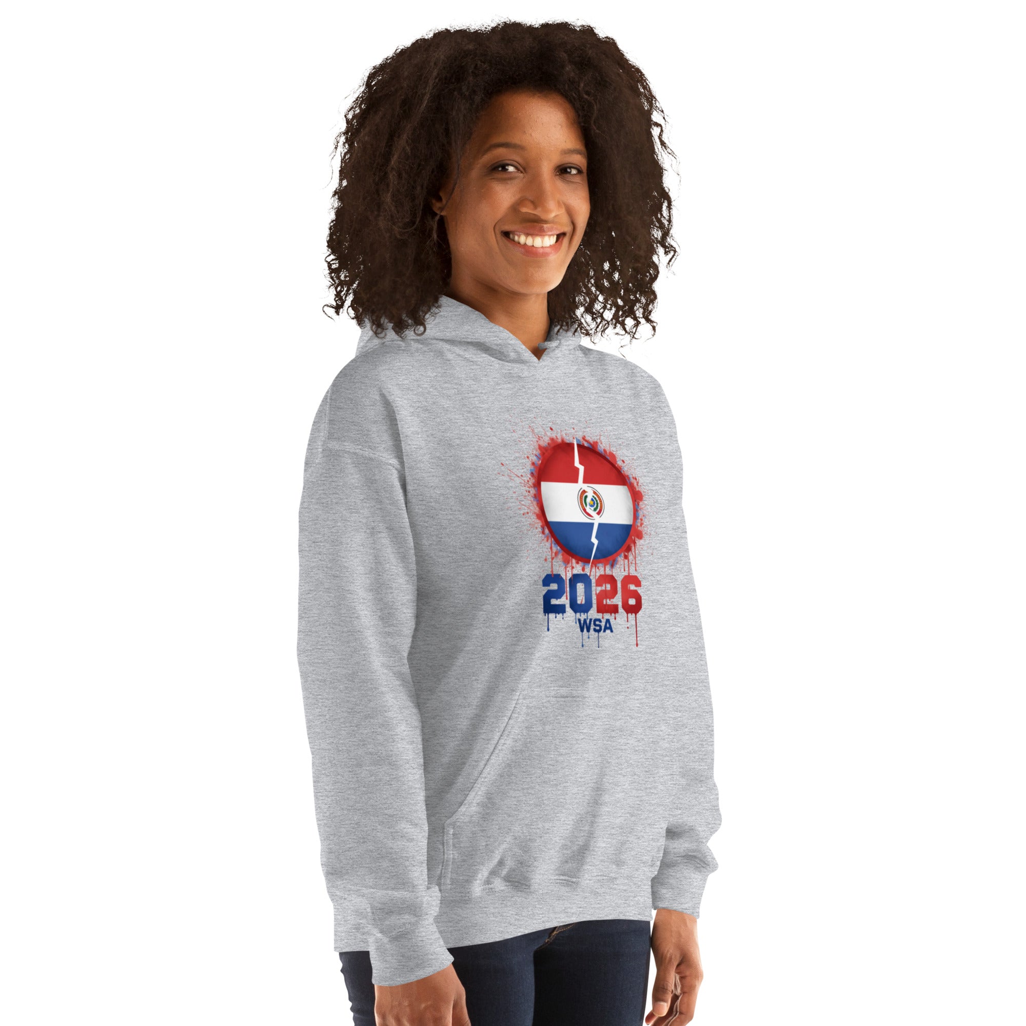 Person wearing a gray hoodie with a design featuring the number 2026 on a white background