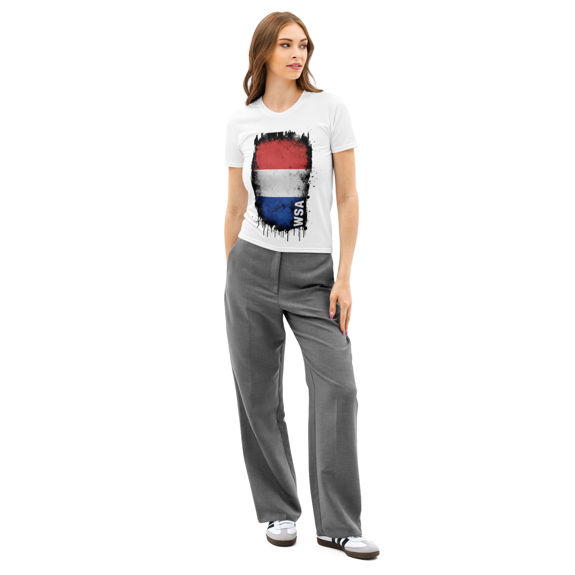 Woman wearing a white t-shirt with a colorful graphic and gray pants on a white background