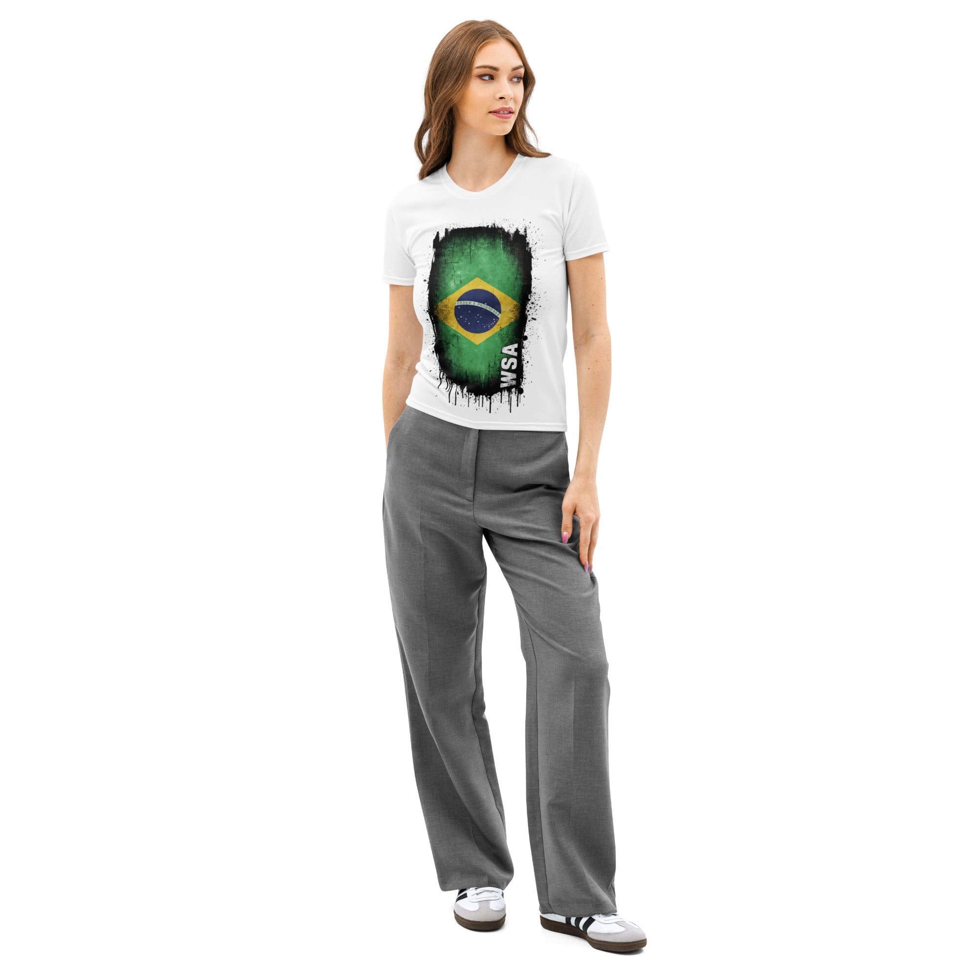 Woman wearing a white t-shirt with a graphic design and gray pants on a white background