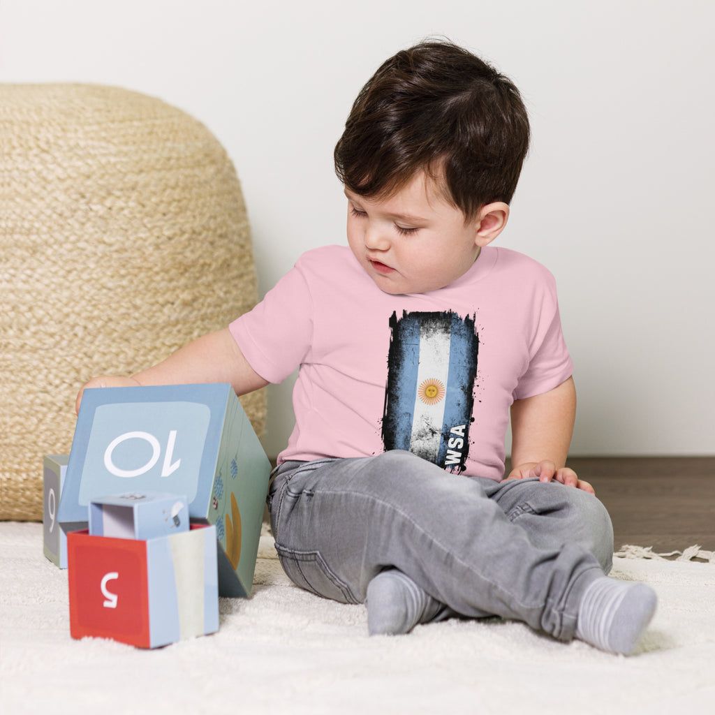 Child sitting on a carpeted floor with educational toys