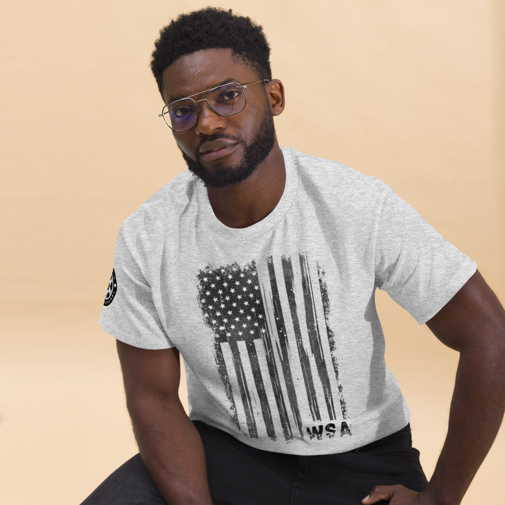 Man wearing a gray t-shirt with an American flag design on a beige background