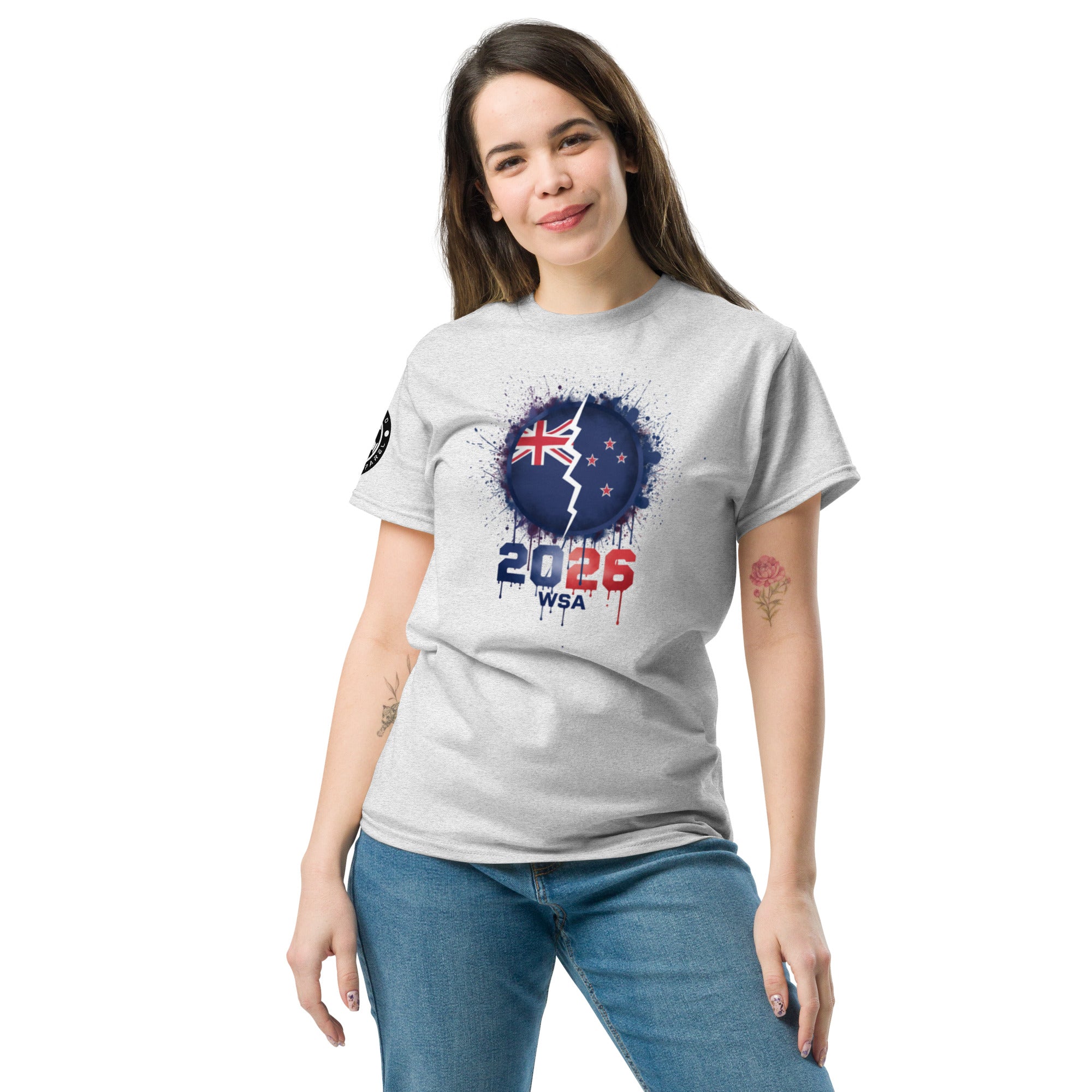 Woman wearing a gray t-shirt with a design featuring the number 2026 and a flag on a white background