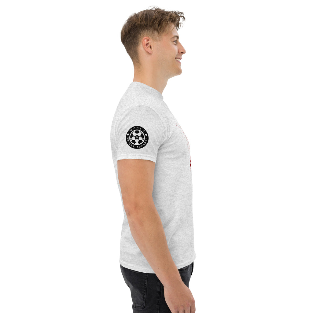 Man wearing a white t-shirt with a black circular logo on the sleeve against a white background