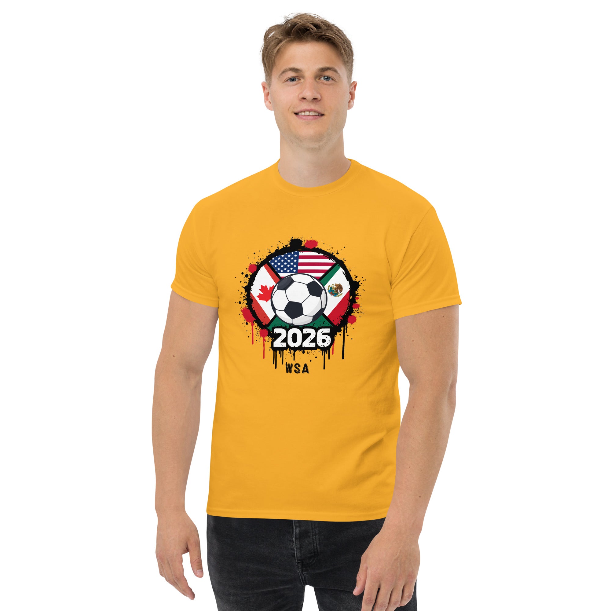 Person wearing a yellow t-shirt with a soccer ball design featuring flags and '2026' text.