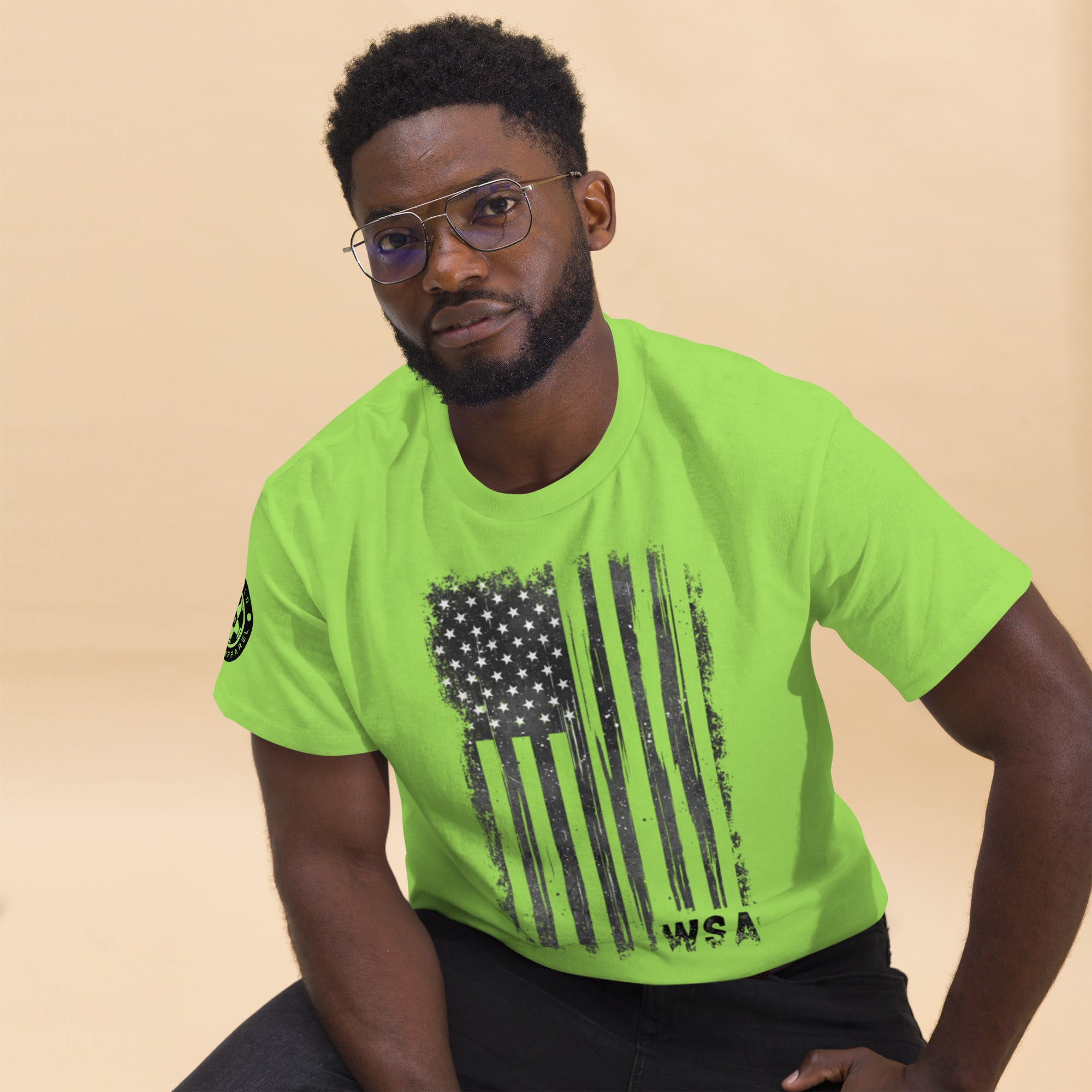 Man wearing a bright green t-shirt with an American flag design on a beige background