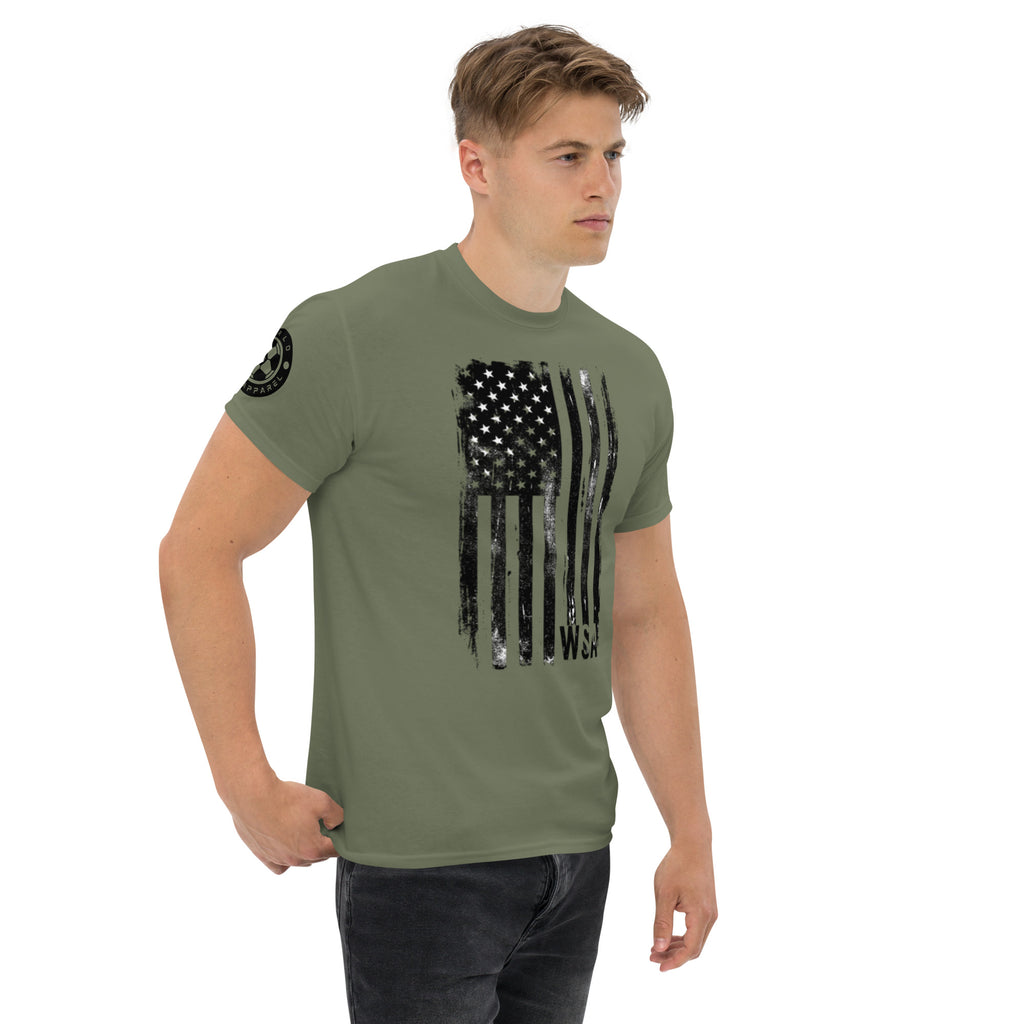 Man wearing a green t-shirt with a black flag design on a white background