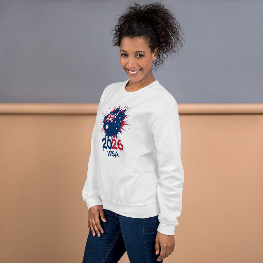 Woman wearing a white sweatshirt with a design and text, standing against a plain background