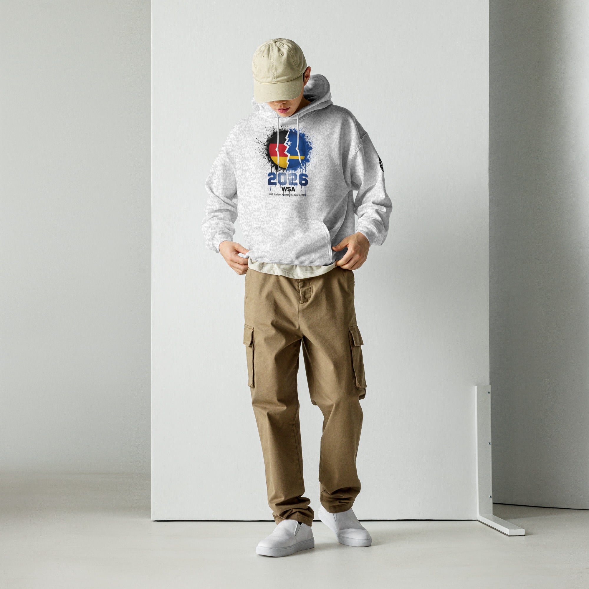 Person wearing a gray hoodie with a colorful logo and brown cargo pants against a white background