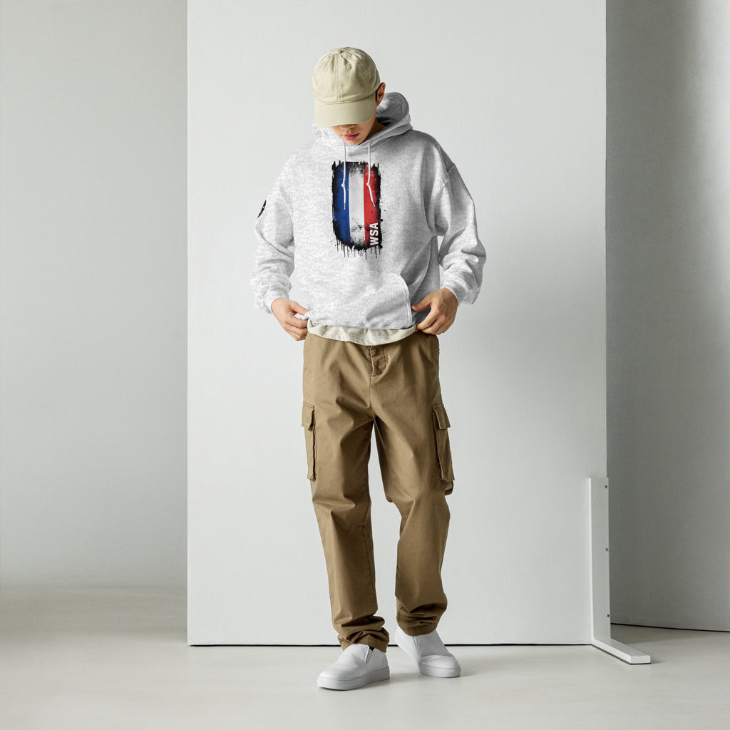 Person wearing a white hoodie with a skull design and brown cargo pants against a plain background