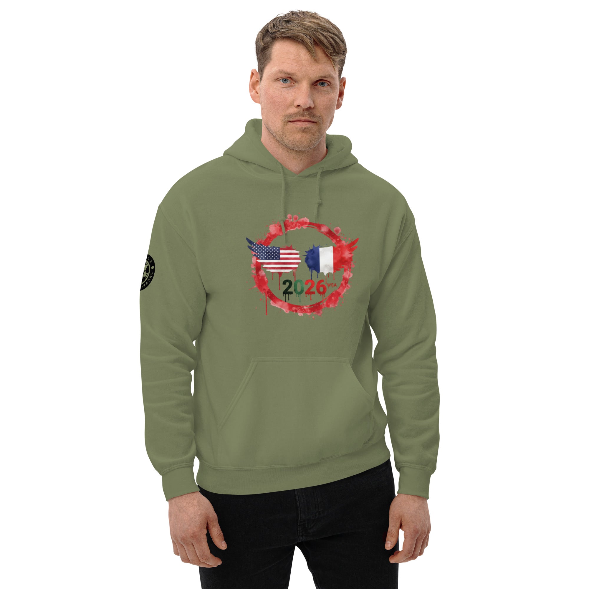 Man wearing a green hoodie with a design featuring American and French flags, and the number 2026.