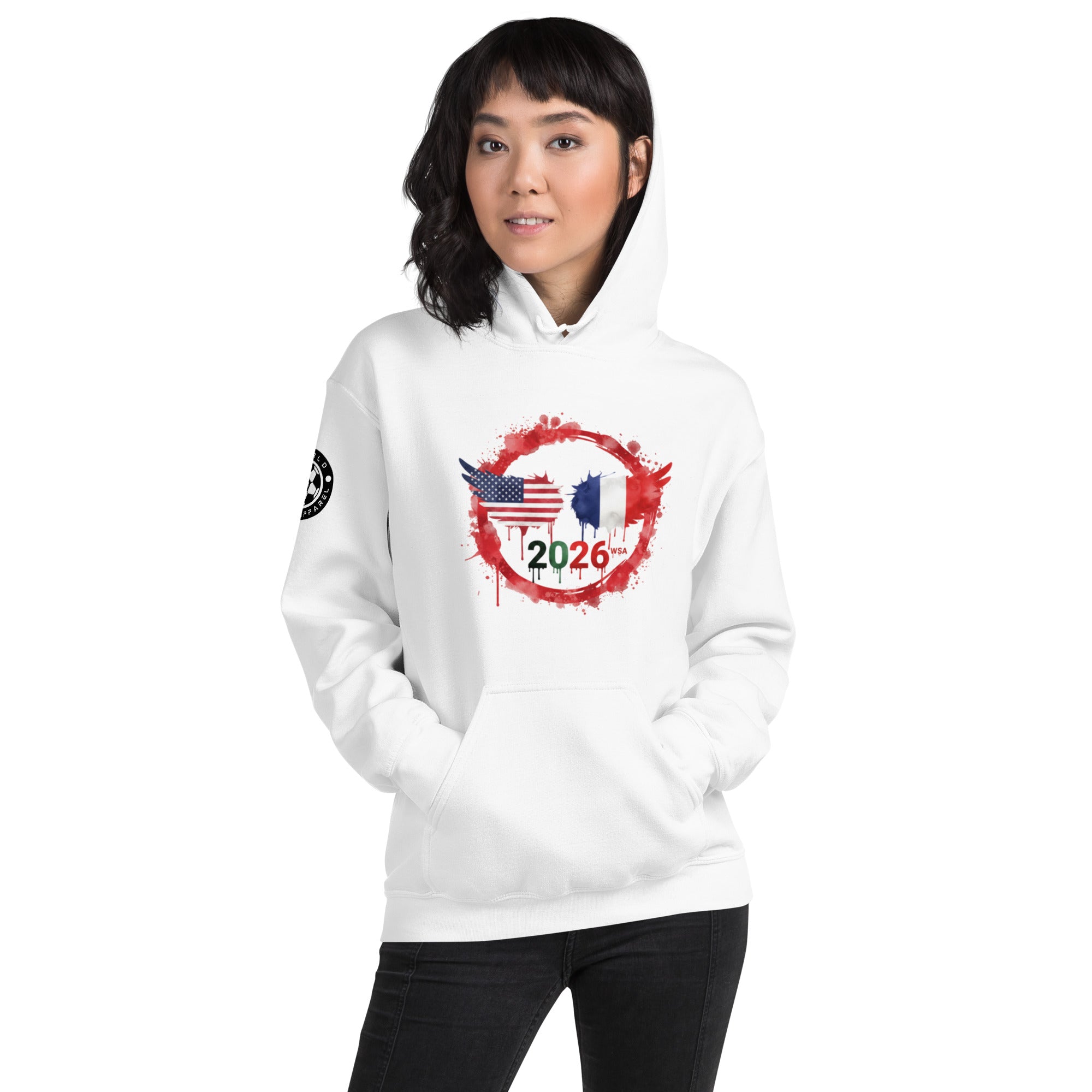 Person wearing a white hoodie with a design featuring the American and French flags and the number 2026 on a white background.