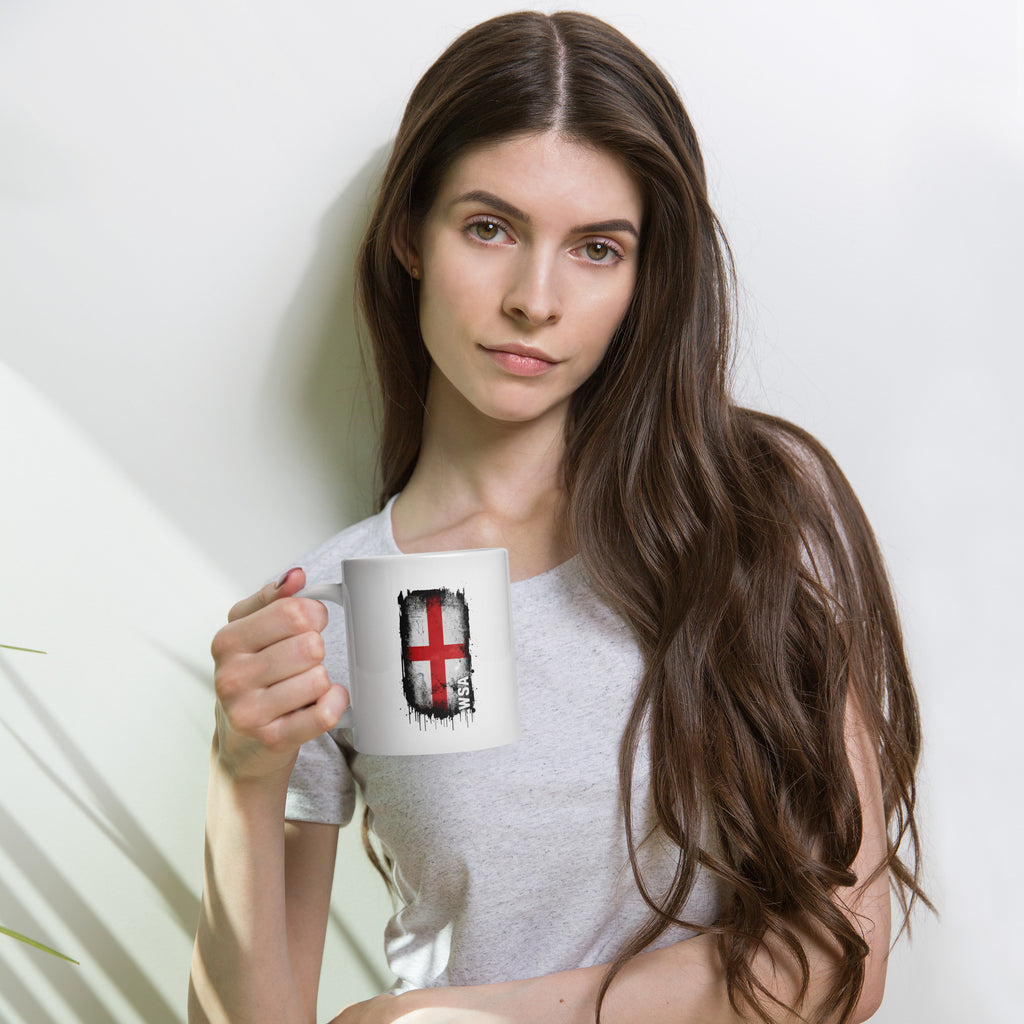 Woman holding a mug with a design on a plain background