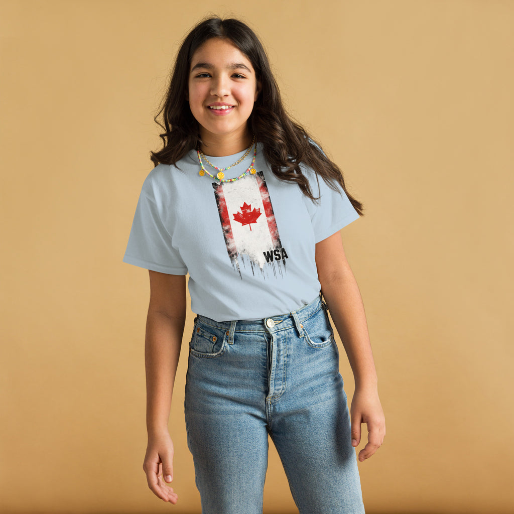Person wearing a light blue t-shirt with a graphic design on a beige background