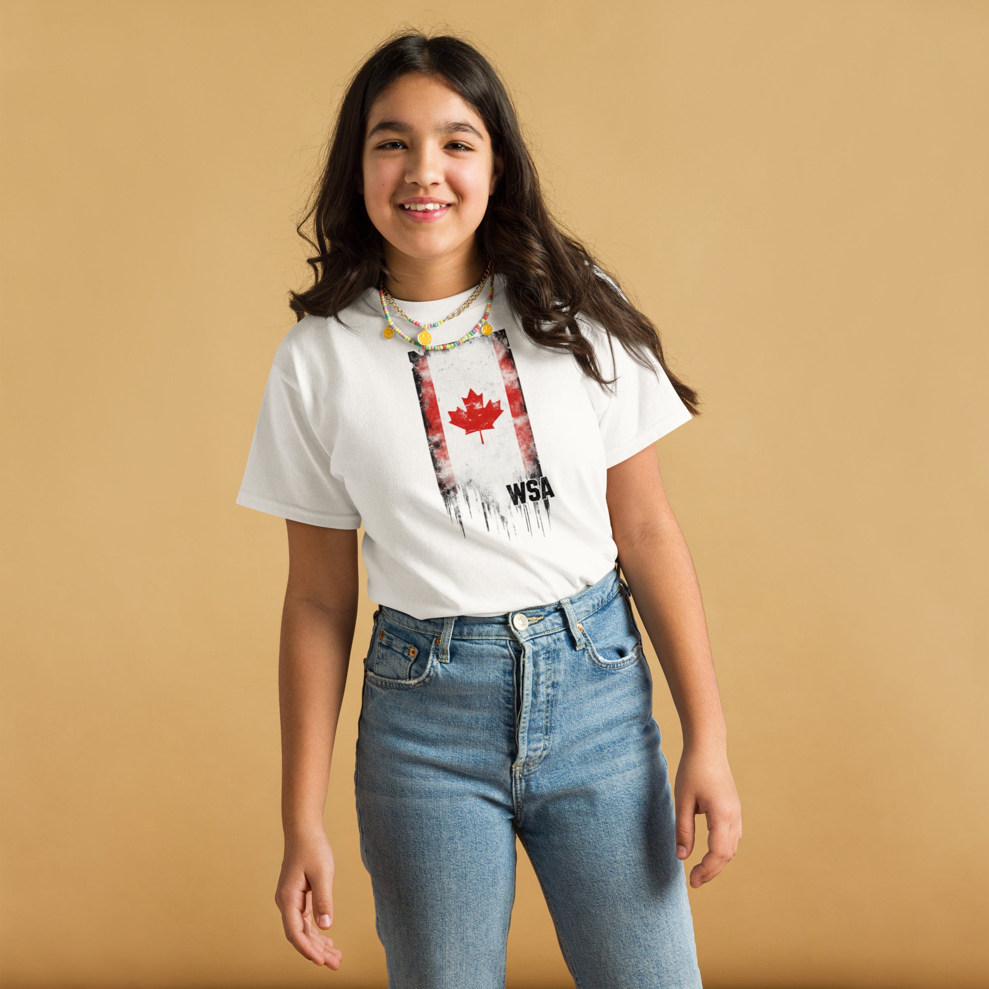 Young girl wearing a white t-shirt with a graphic design on a beige background