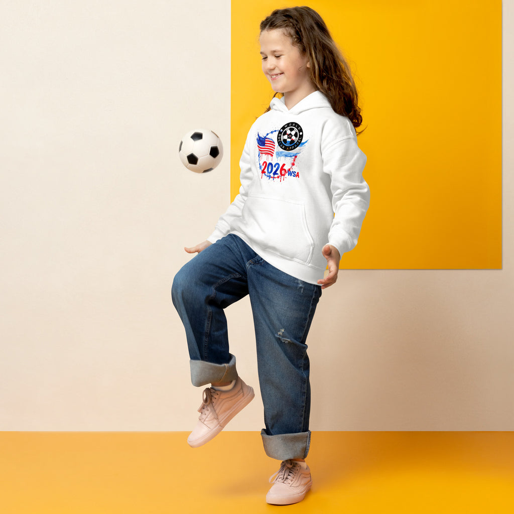 Child wearing a white hoodie with a soccer design, kicking a soccer ball against a yellow and beige background